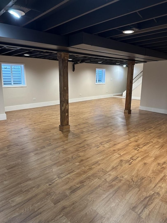 1691 Bilter Rd, Aurora, IL 60502 - basement featuring wood finished floors, healthy amount of natural light, and stairs