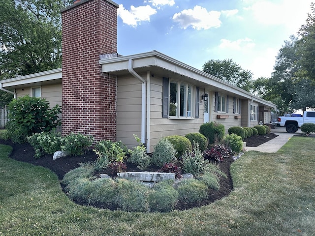 1691 Bilter Rd, Aurora, IL 60502 - view of side of home with a chimney and a lawn