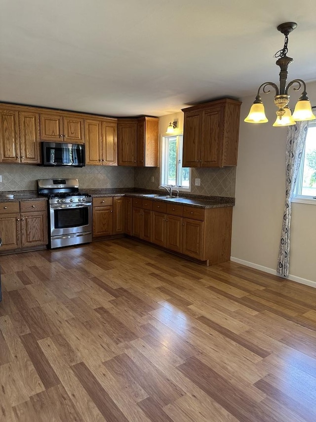 1691 Bilter Rd, Aurora, IL 60502 - kitchen featuring appliances with stainless steel finishes, dark countertops, and healthy amount of natural light