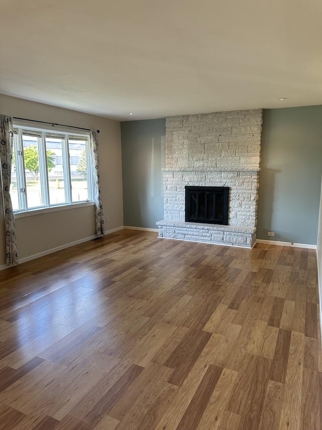 1691 Bilter Rd, Aurora, IL 60502 - unfurnished living room with wood finished floors, a fireplace, and recessed lighting