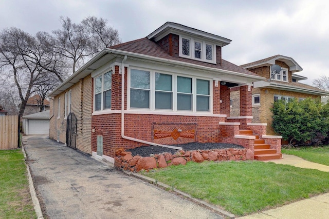 1825 S 8th Ave, Maywood, IL 60153 - bungalow-style house featuring brick siding, an outdoor structure, a garage, and a front yard