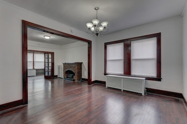 1825 S 8th Ave, Maywood, IL 60153 - unfurnished living room with radiator heating unit, a chandelier, wood finished floors, ornamental molding, and a fireplace