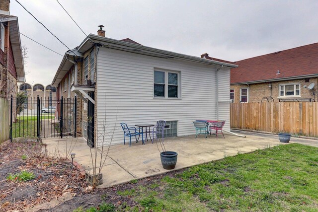 1825 S 8th Ave, Maywood, IL 60153 - rear view of house featuring a patio and a chimney