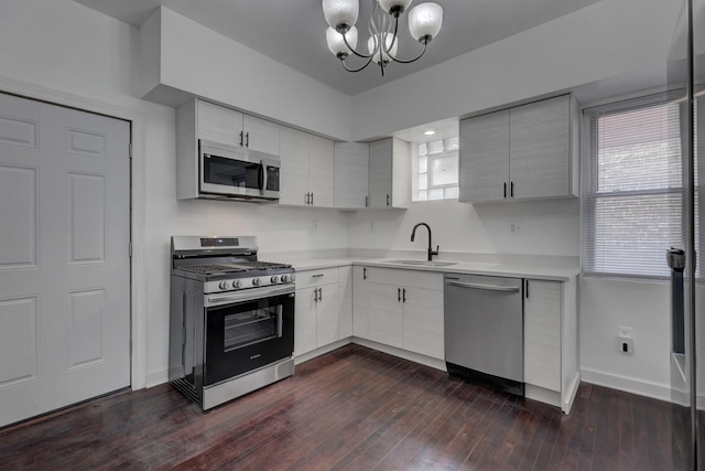 1825 S 8th Ave, Maywood, IL 60153 - kitchen with stainless steel appliances, light countertops, a chandelier, and dark wood-style floors