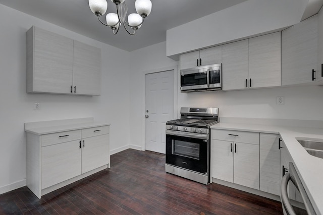 1825 S 8th Ave, Maywood, IL 60153 - kitchen with stainless steel appliances, dark wood-type flooring, a chandelier, and light countertops
