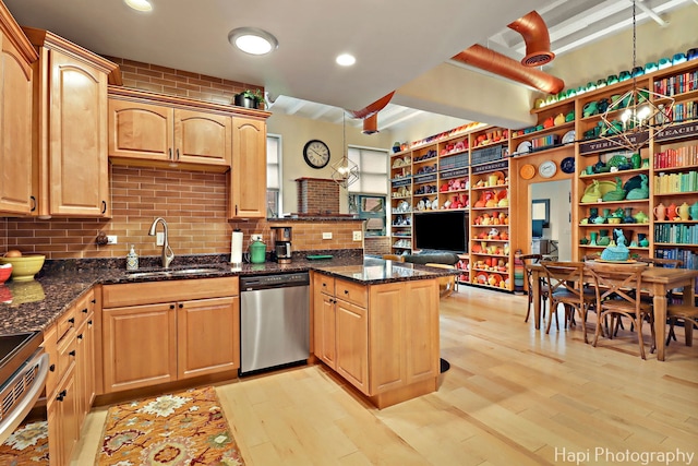110 N 2nd St Unit 4, West Dundee, IL 60118 - kitchen with stainless steel dishwasher, a peninsula, stove, light wood-style flooring, and dark stone countertops