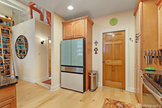 110 N 2nd St Unit 4, West Dundee, IL 60118 - kitchen with light wood finished floors, dark stone countertops, stainless steel electric range oven, freestanding refrigerator, and recessed lighting