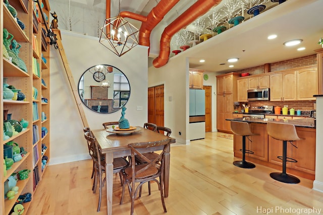 110 N 2nd St Unit 4, West Dundee, IL 60118 - dining space with light wood-style floors, a chandelier, and recessed lighting