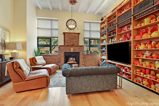 110 N 2nd St Unit 4, West Dundee, IL 60118 - living room with beam ceiling, wood finished floors, a chandelier, and a fireplace
