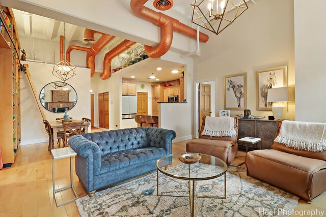 110 N 2nd St Unit 4, West Dundee, IL 60118 - living area with a chandelier, light wood-style floors, and a high ceiling