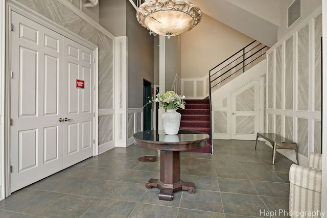 110 N 2nd St Unit 4, West Dundee, IL 60118 - tiled foyer entrance featuring stairs, a decorative wall, and a high ceiling