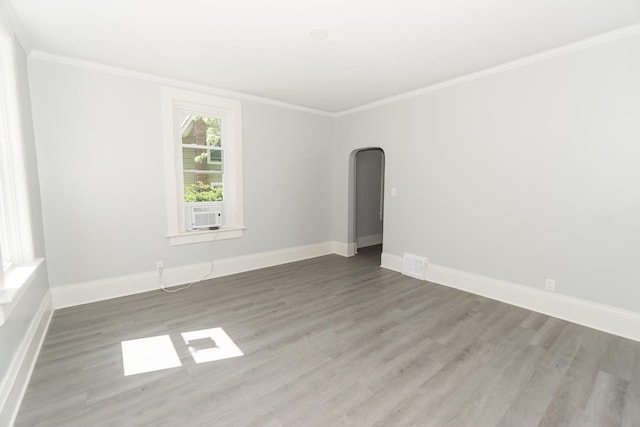 328 Silver St, Elgin, IL 60123 - spare room with wood finished floors, crown molding, arched walkways, and cooling unit