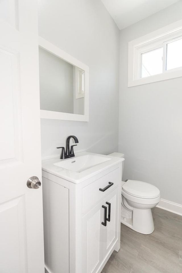 328 Silver St, Elgin, IL 60123 - half bathroom featuring vanity and wood finished floors