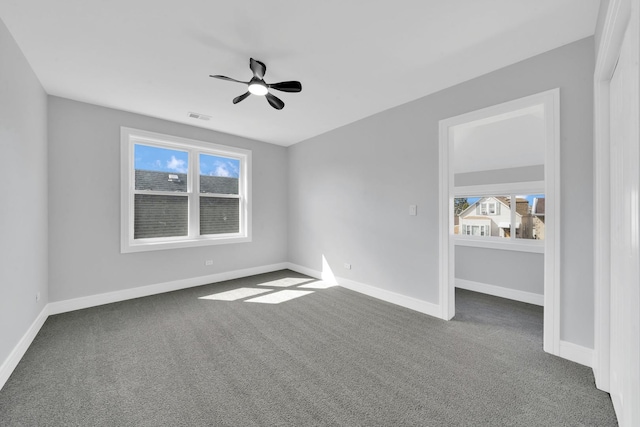 2613 Kenilworth Ave, Berwyn, IL 60402 - empty room with dark colored carpet and a ceiling fan