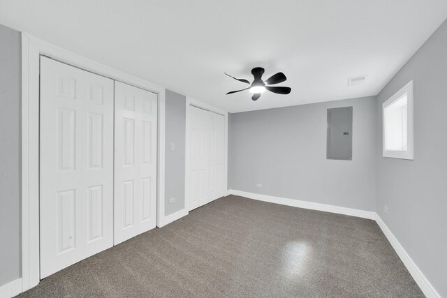 2613 Kenilworth Ave, Berwyn, IL 60402 - unfurnished bedroom featuring electric panel, two closets, ceiling fan, and dark carpet