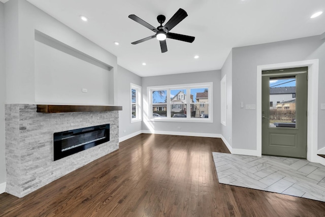 2613 Kenilworth Ave, Berwyn, IL 60402 - unfurnished living room featuring a ceiling fan, a stone fireplace, wood finished floors, and recessed lighting