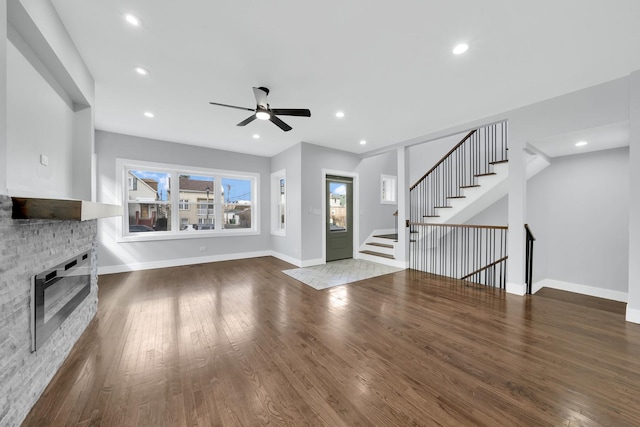 2613 Kenilworth Ave, Berwyn, IL 60402 - unfurnished living room featuring a ceiling fan, wood finished floors, a stone fireplace, stairway, and recessed lighting