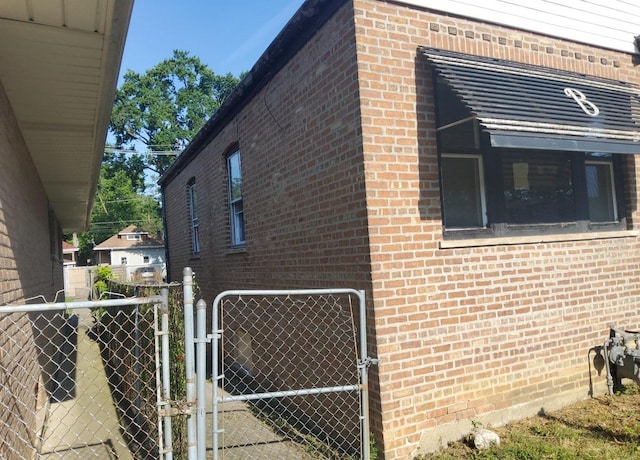 15734 Marshfield Ave, Harvey, IL 60426 - view of side of property featuring a gate and brick siding
