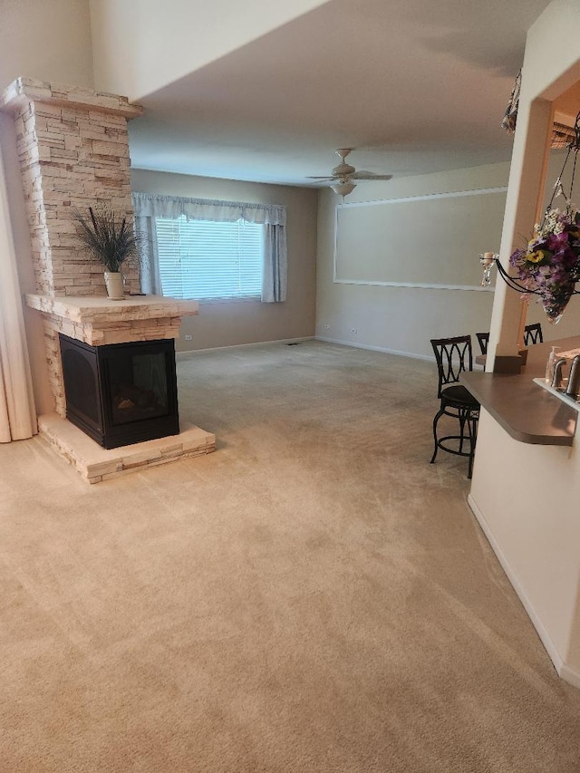 247 Lillian Ct, Geneva, IL 60134 - carpeted living area featuring ceiling fan and a stone fireplace