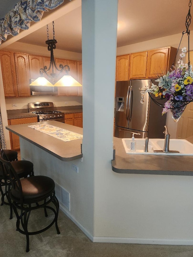 247 Lillian Ct, Geneva, IL 60134 - kitchen with stainless steel appliances, ventilation hood, a kitchen bar, and carpet