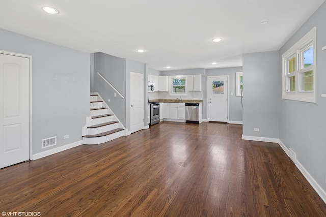 5051 Wright Ter, Skokie, IL 60077 - unfurnished living room featuring stairway, dark wood finished floors, and recessed lighting
