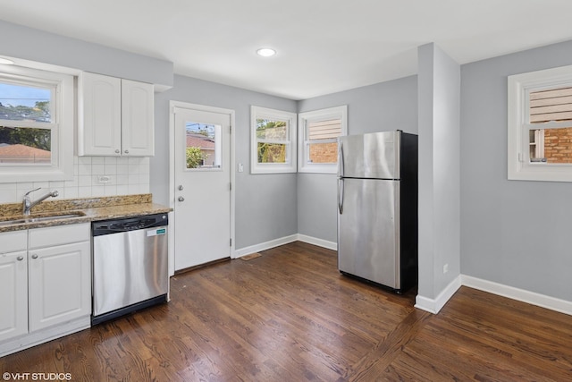 5051 Wright Ter, Skokie, IL 60077 - kitchen featuring stainless steel appliances, light stone countertops, dark wood-style flooring, white cabinetry, and recessed lighting