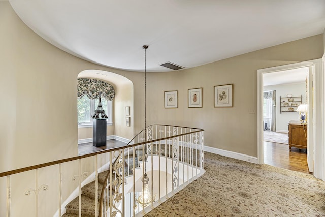 1755 Sunset Ln, Bannockburn, IL 60015 - corridor featuring arched walkways, an upstairs landing, and carpet floors