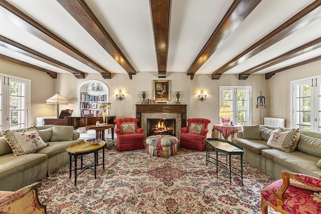 1755 Sunset Ln, Bannockburn, IL 60015 - carpeted living area featuring radiator, a premium fireplace, and beamed ceiling