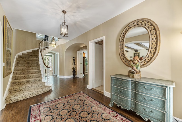 1755 Sunset Ln, Bannockburn, IL 60015 - entrance foyer with arched walkways, wood finished floors, stairway, and a chandelier