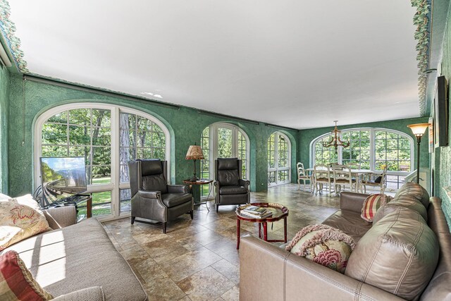 1755 Sunset Ln, Bannockburn, IL 60015 - living room with stone tile flooring, plenty of natural light, and a chandelier