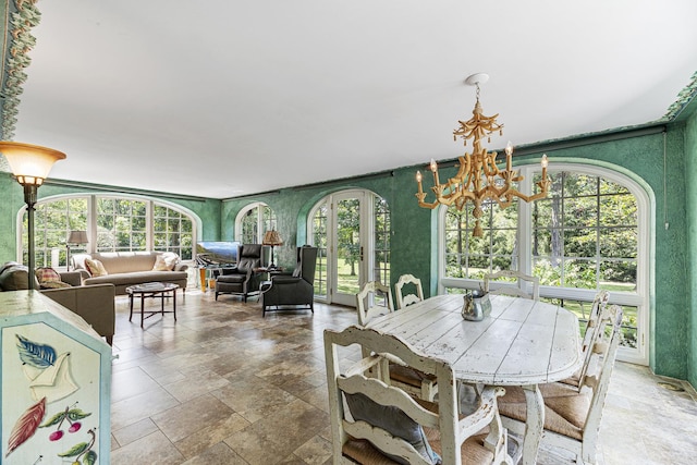 1755 Sunset Ln, Bannockburn, IL 60015 - dining space with stone tile floors, healthy amount of natural light, and a chandelier