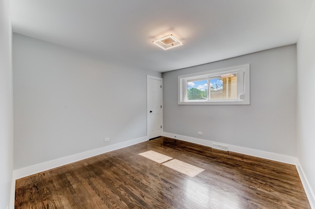 422 W 98th Pl, Chicago, IL 60628 - unfurnished room featuring baseboards and dark wood-style floors