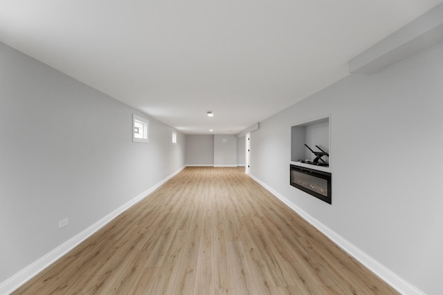 422 W 98th Pl, Chicago, IL 60628 - empty room with light wood-type flooring and a glass covered fireplace
