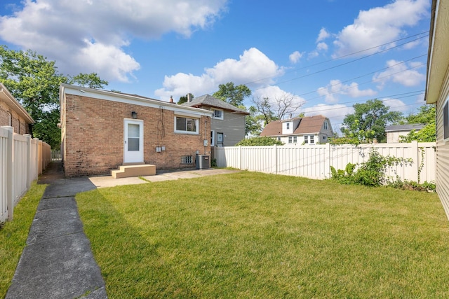 422 W 98th Pl, Chicago, IL 60628 - rear view of property with brick siding, entry steps, a fenced backyard, and a patio
