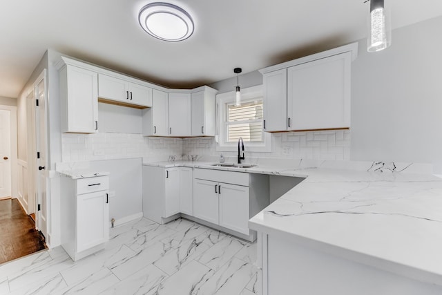 422 W 98th Pl, Chicago, IL 60628 - kitchen with light stone counters, decorative light fixtures, white cabinets, and decorative backsplash