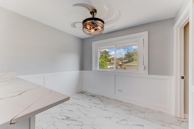 422 W 98th Pl, Chicago, IL 60628 - unfurnished dining area with light marble finish floors and a wainscoted wall