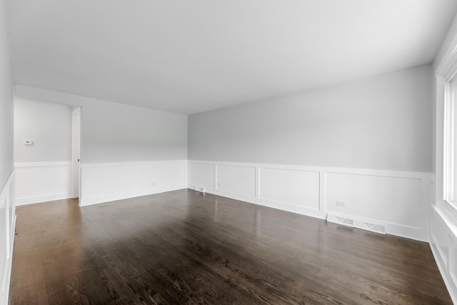 422 W 98th Pl, Chicago, IL 60628 - spare room with wainscoting, dark wood-style flooring, and a decorative wall