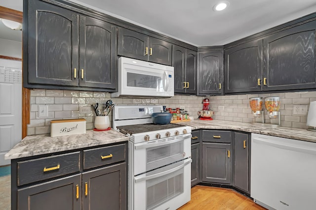 2570 Cobblestone Ct, Morris, IL 60450 - kitchen with white appliances, backsplash, light wood finished floors, and recessed lighting