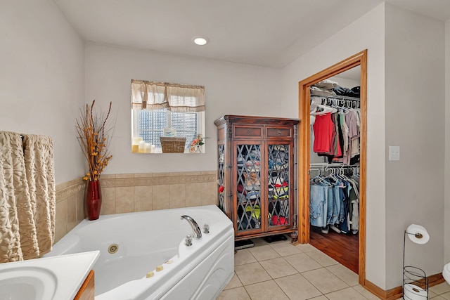2570 Cobblestone Ct, Morris, IL 60450 - bathroom featuring a whirlpool tub, tile patterned flooring, a walk in closet, and vanity