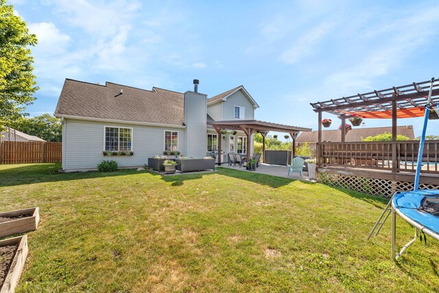 2570 Cobblestone Ct, Morris, IL 60450 - rear view of property featuring a trampoline, a pergola, a chimney, a patio, and outdoor lounge area