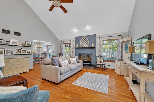 2570 Cobblestone Ct, Morris, IL 60450 - living area featuring high vaulted ceiling, a ceiling fan, a fireplace, light wood finished floors, and recessed lighting