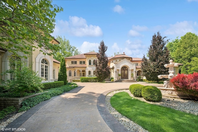 1031 Barrys Ct, Lake Forest, IL 60045 - mediterranean / spanish house with stucco siding, stone siding, and curved driveway