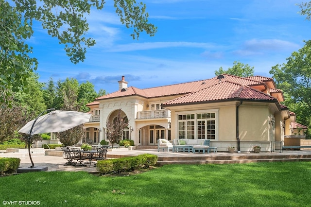 1031 Barrys Ct, Lake Forest, IL 60045 - back of property with a balcony, a chimney, an outdoor living space, a lawn, and a patio area