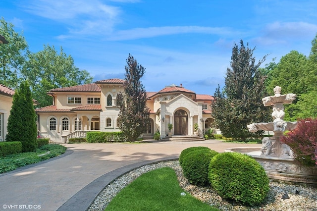 1031 Barrys Ct, Lake Forest, IL 60045 - mediterranean / spanish-style house with a tiled roof, stucco siding, stone siding, and curved driveway