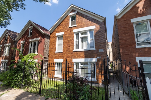 2745 S Sawyer Ave, Chicago, IL 60623 - view of front facade with a fenced front yard, brick siding, and a gate