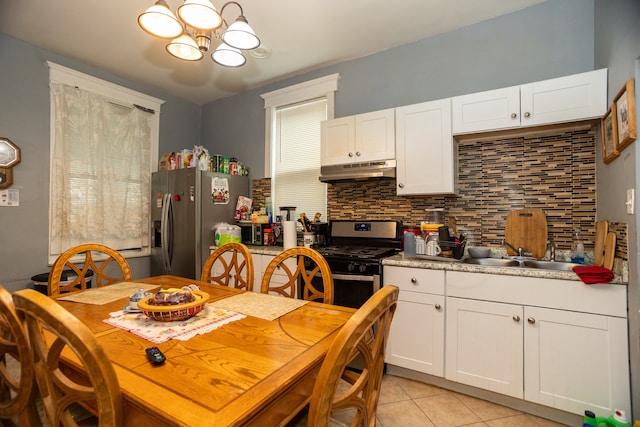 2745 S Sawyer Ave, Chicago, IL 60623 - dining space with a chandelier and light tile patterned floors
