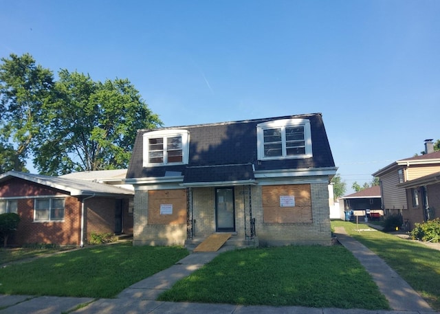 15944 Paulina St, Harvey, IL 60426 - view of front of house with mansard roof, brick siding, roof with shingles, and a front lawn
