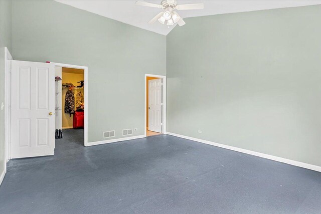 25612 W Woodlawn Ave, Antioch, IL 60002 - unfurnished bedroom featuring high vaulted ceiling, a spacious closet, a closet, ceiling fan, and finished concrete flooring
