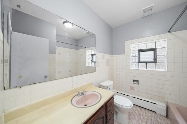 1802 S 50th Ave, Cicero, IL 60804 - full bathroom featuring tile walls, a baseboard heating unit, tile patterned floors, vanity, and plenty of natural light