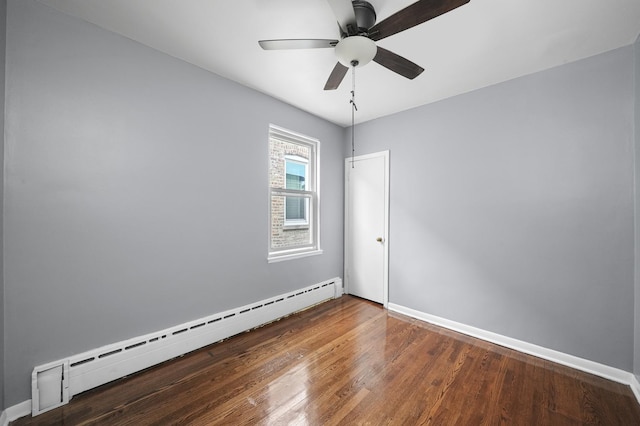 1802 S 50th Ave, Cicero, IL 60804 - spare room featuring a baseboard heating unit, a ceiling fan, and wood finished floors